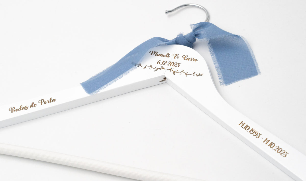 Cintre blanc avec nœud bleu, prénoms, date et «Bodas de Plata» gravés