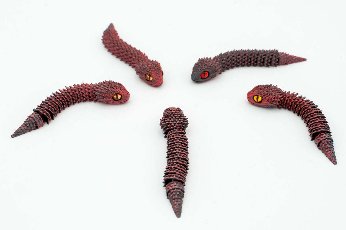 Serpents 3D articulés dans des tons rouge foncé vus de près
