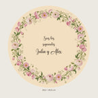 Aperçu numérique : pancarte ronde avec fleurs rose pâle et texte «Sois los siguientes» pour Julia et Álex, prénoms d’exemple.