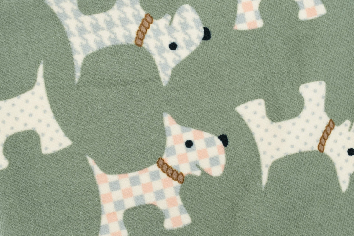 Gros plan d'une serviette vert olive à motifs de petits chiens pastel