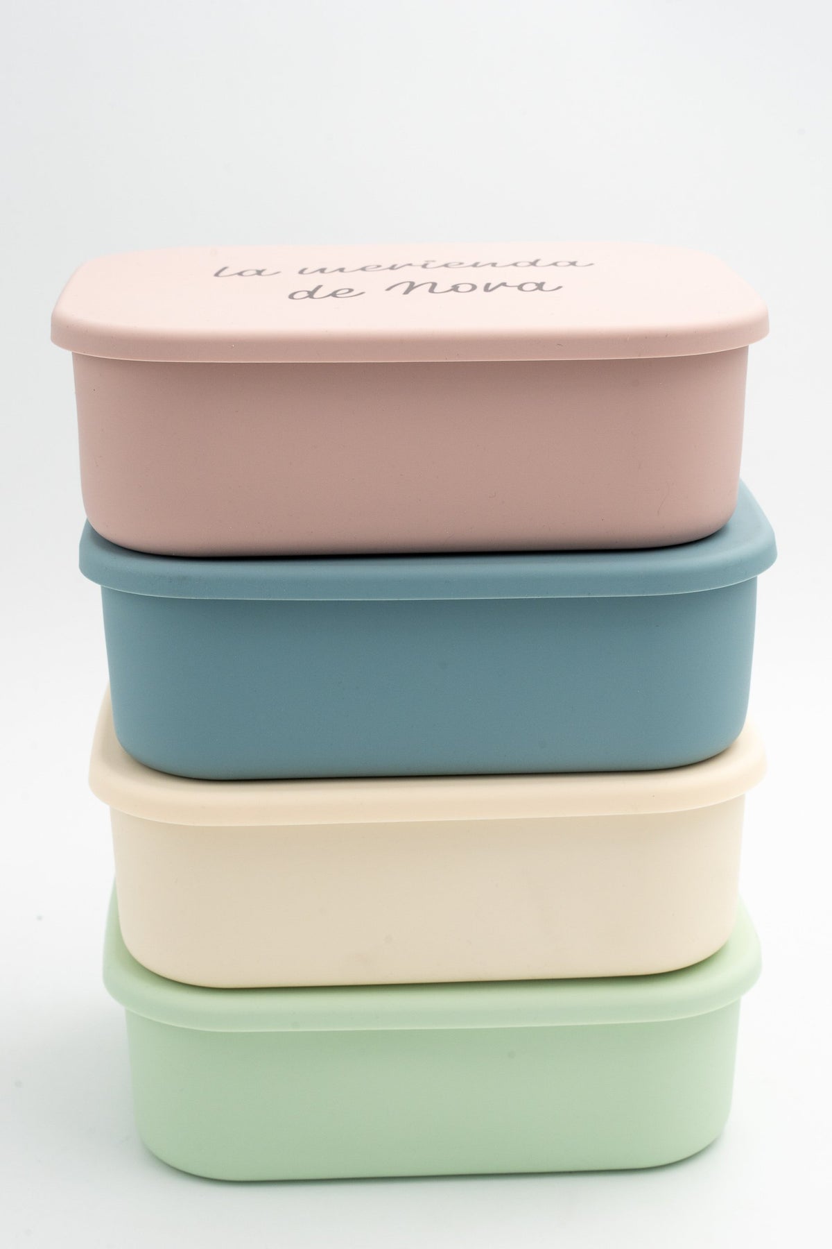 Boîtes repas XL empilées en rose, bleu, crème et vert